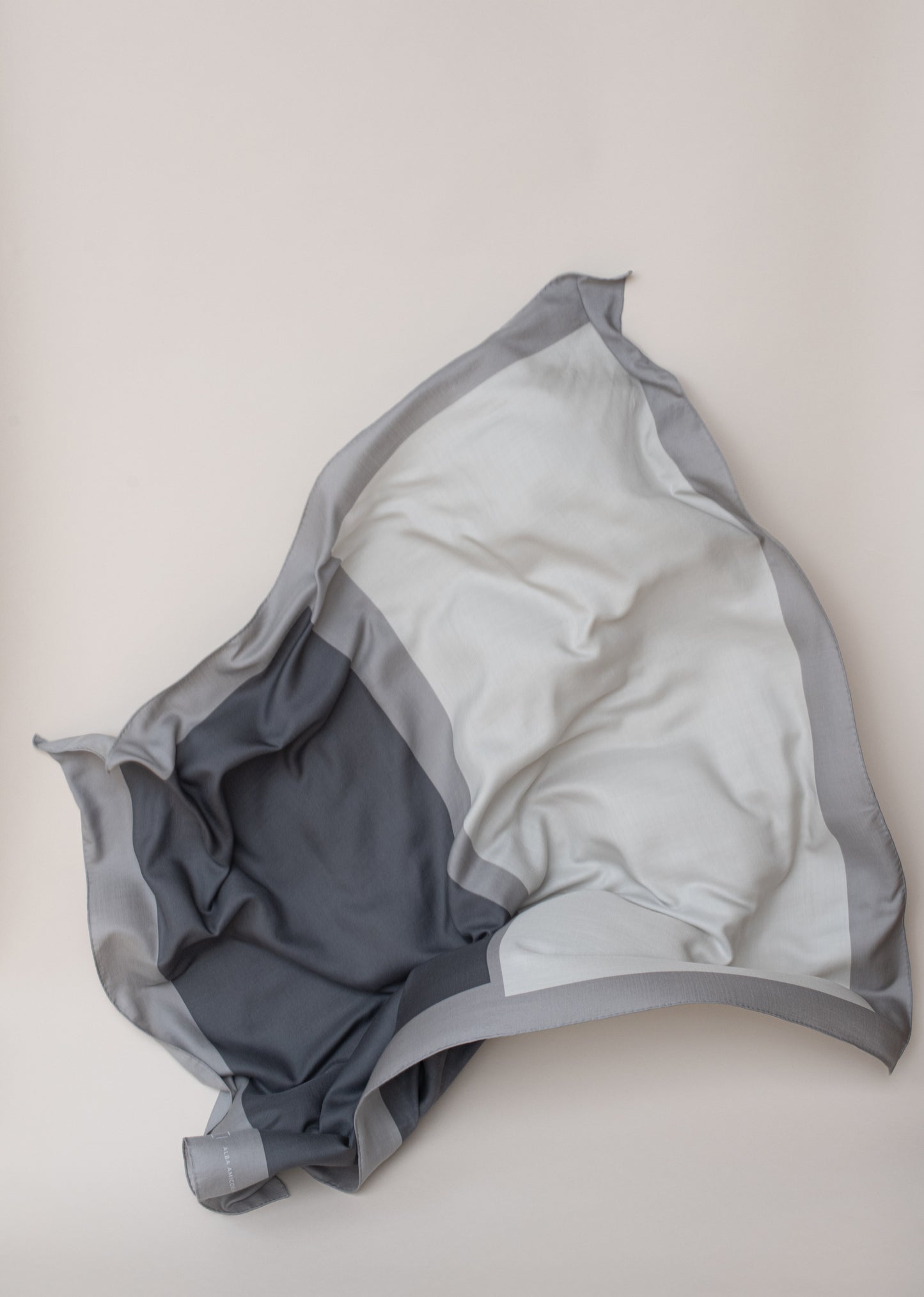 Intonation 02, soft woollen shawl by Alba Amicorum, in grey tones, hand rolled hems