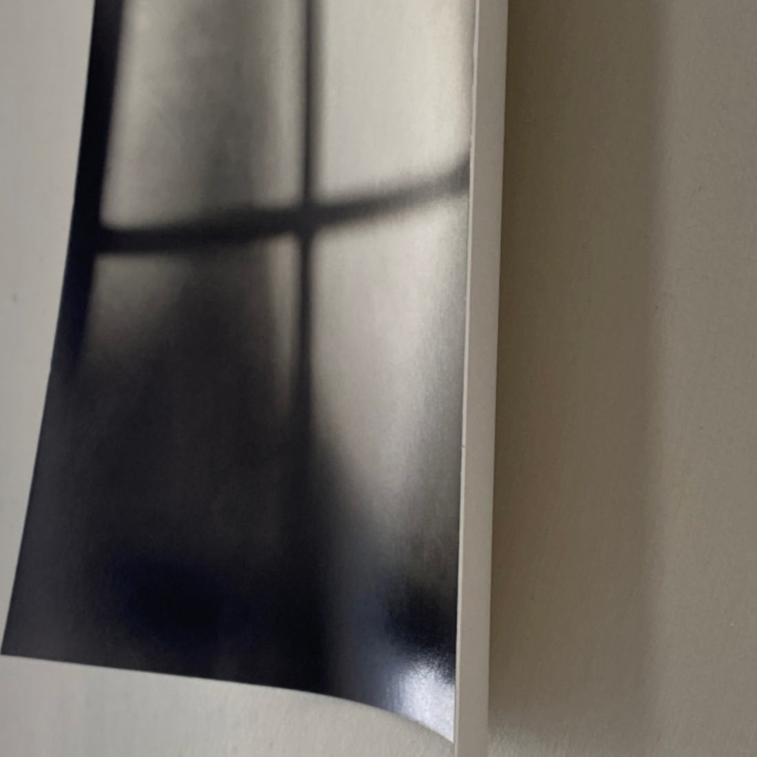 Photo of a soft focus photograph hanging loosely on a beige wall