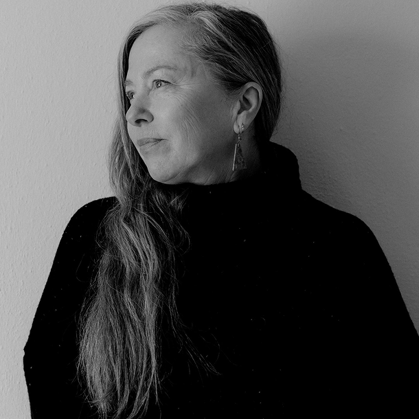 Photo of Dot Wade looking off to the left of the screen into sunlight