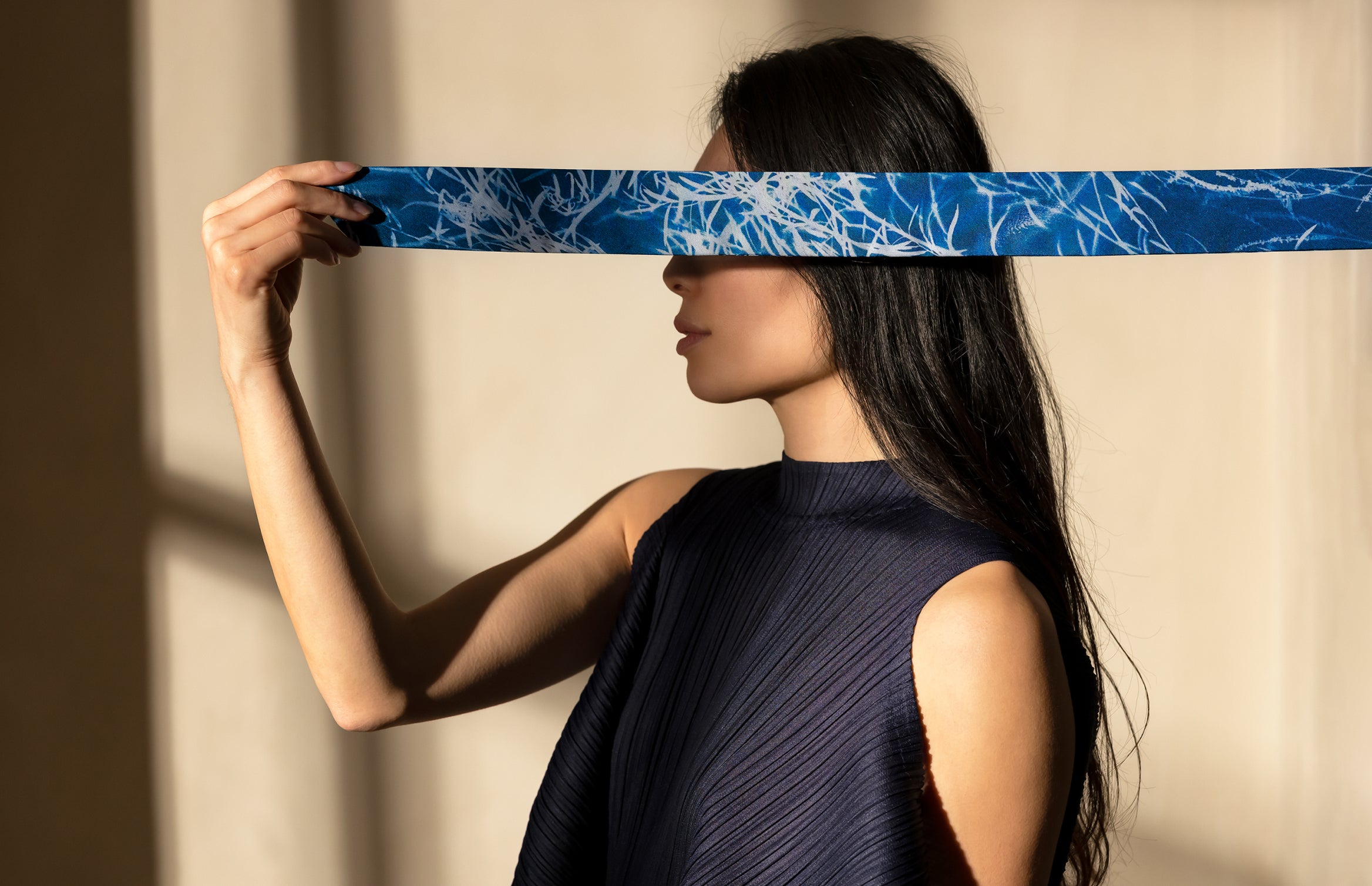 profile of woman in dramatic light with Twilly scarf Indigo Summer by Deni Javas covering her eyes 