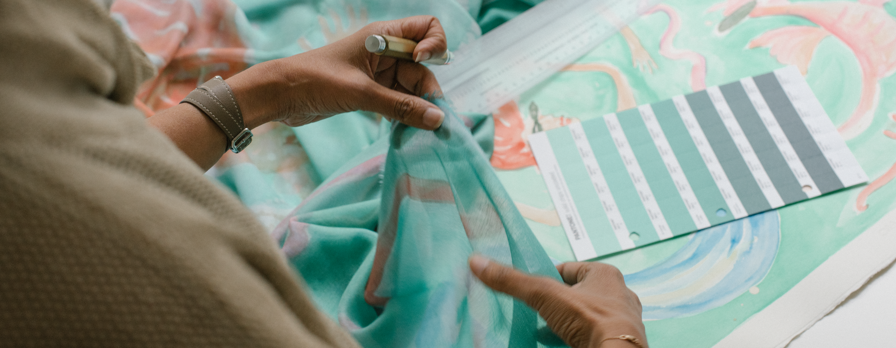 An artist in the process of making an Alba Amicorum scarf that is beautifully patterned pastel abstraction
