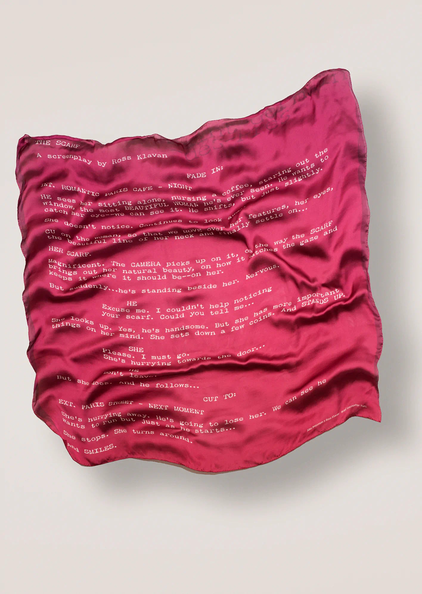 Ross Klavan text-based scarf in pink on a light gray background