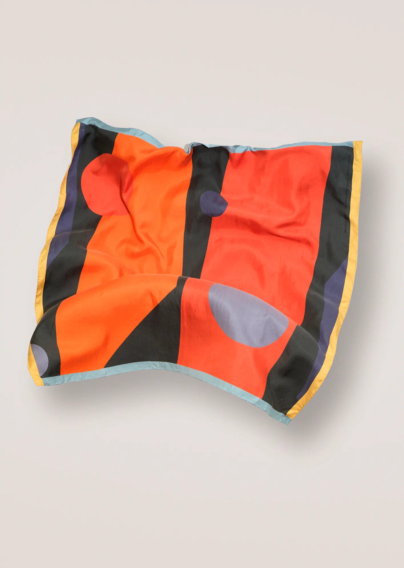 Colorful square scarf by Darshana Shilpi Rouget with abstract patterns on a beige background 