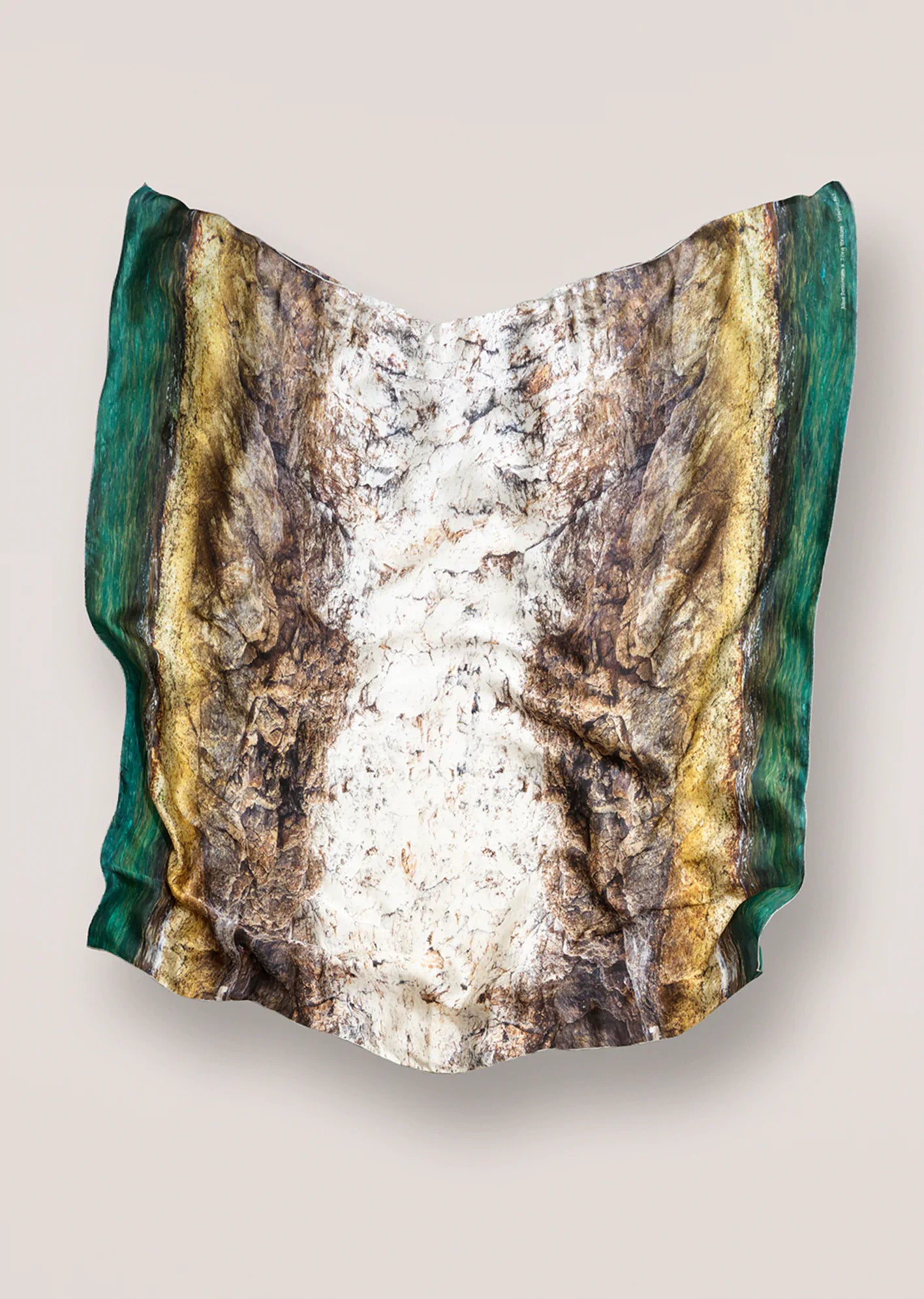Jorg Brauer scarf  resembling a geological sample with layered rock on a beige background