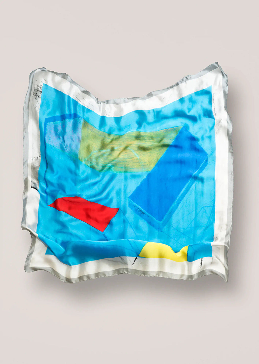 Colorful Naomi Frears scarf on a light gray background