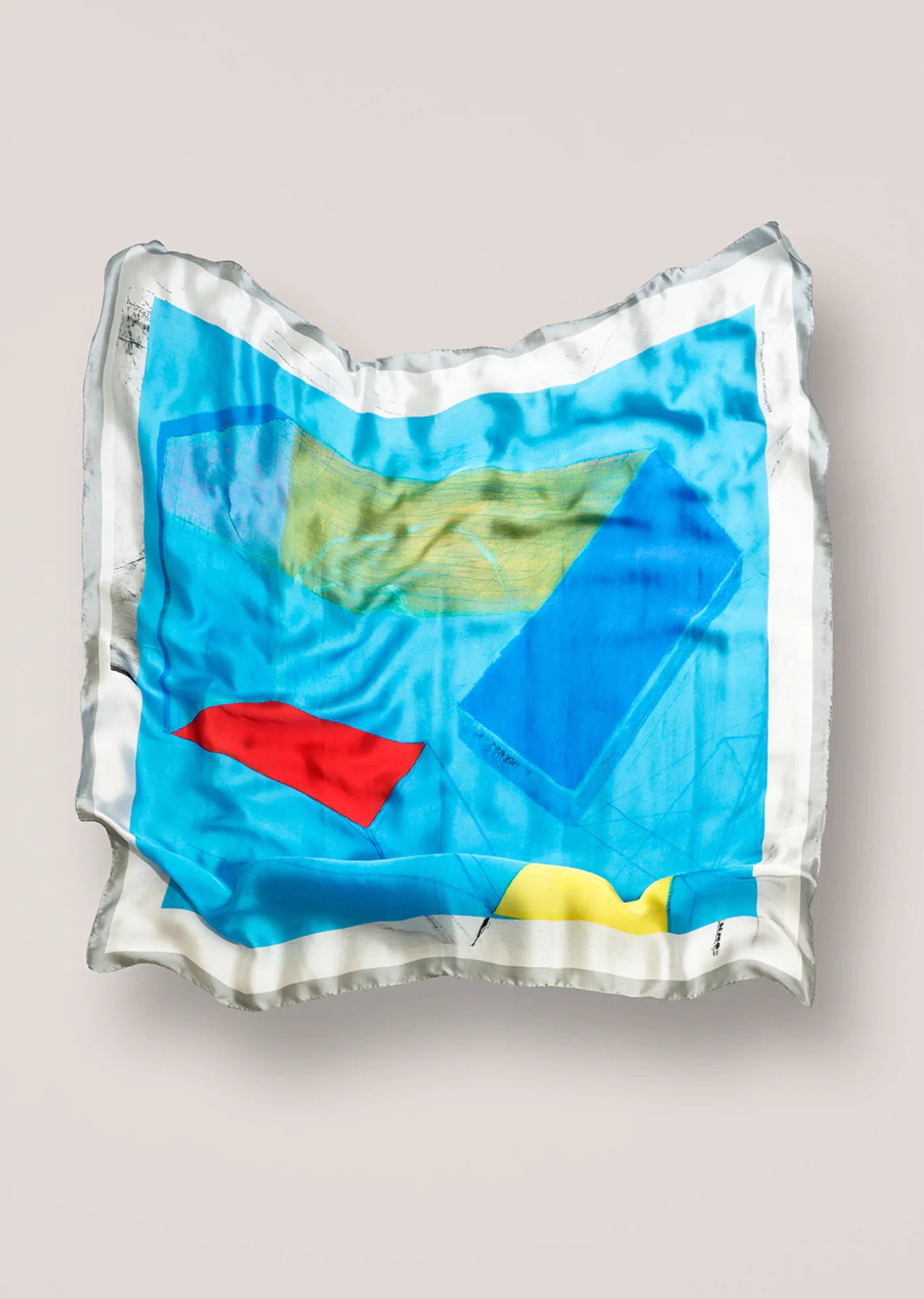 Colorful Naomi Frears scarf on a light gray background