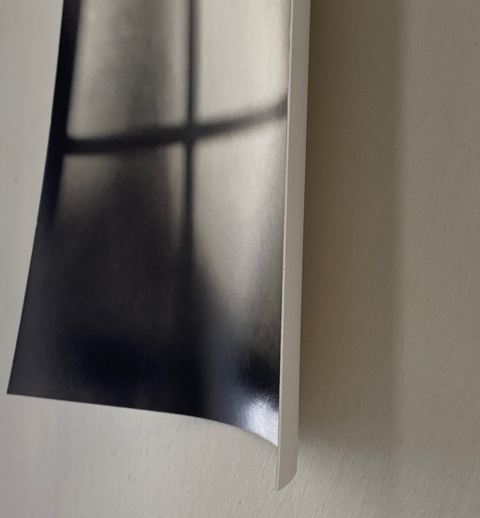 Photo of a soft focus photograph hanging loosely on a beige wall