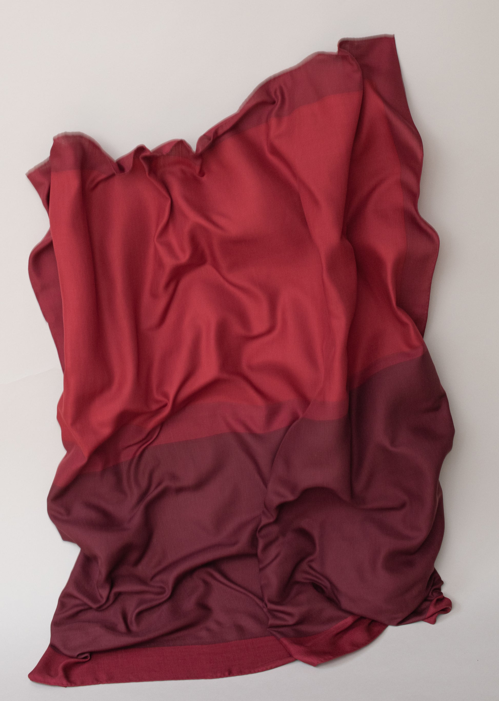 Intonation 01, soft woollen shawl by Alba Amicorum, in red tones, hand rolled hems