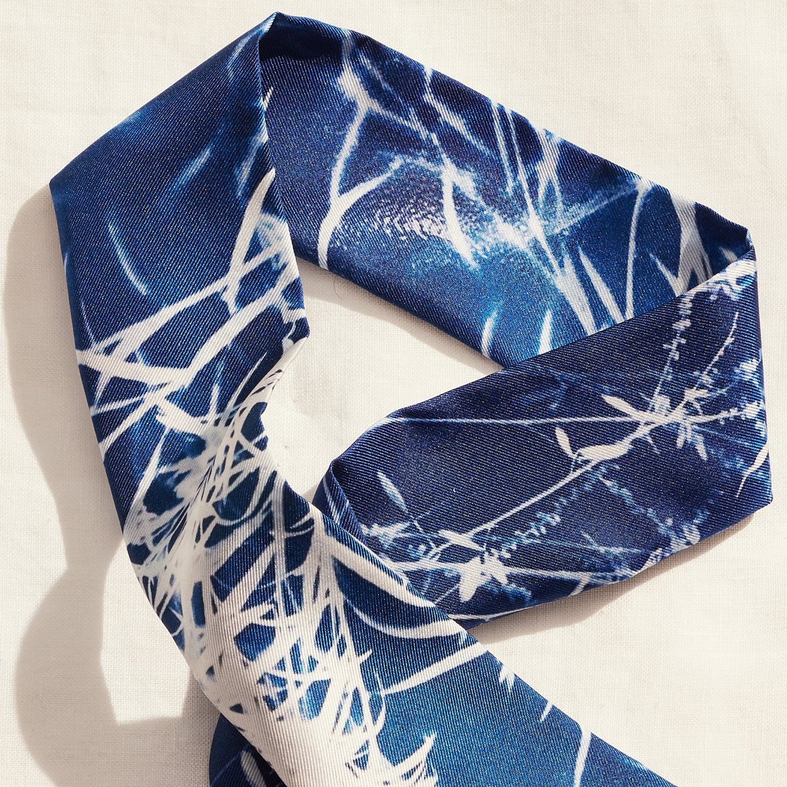 limited edition of 80, 5cm x 86cm, Made in Italy, 100% silk twilly scarf made in Artist Deni Javas’s signature cyanotype style